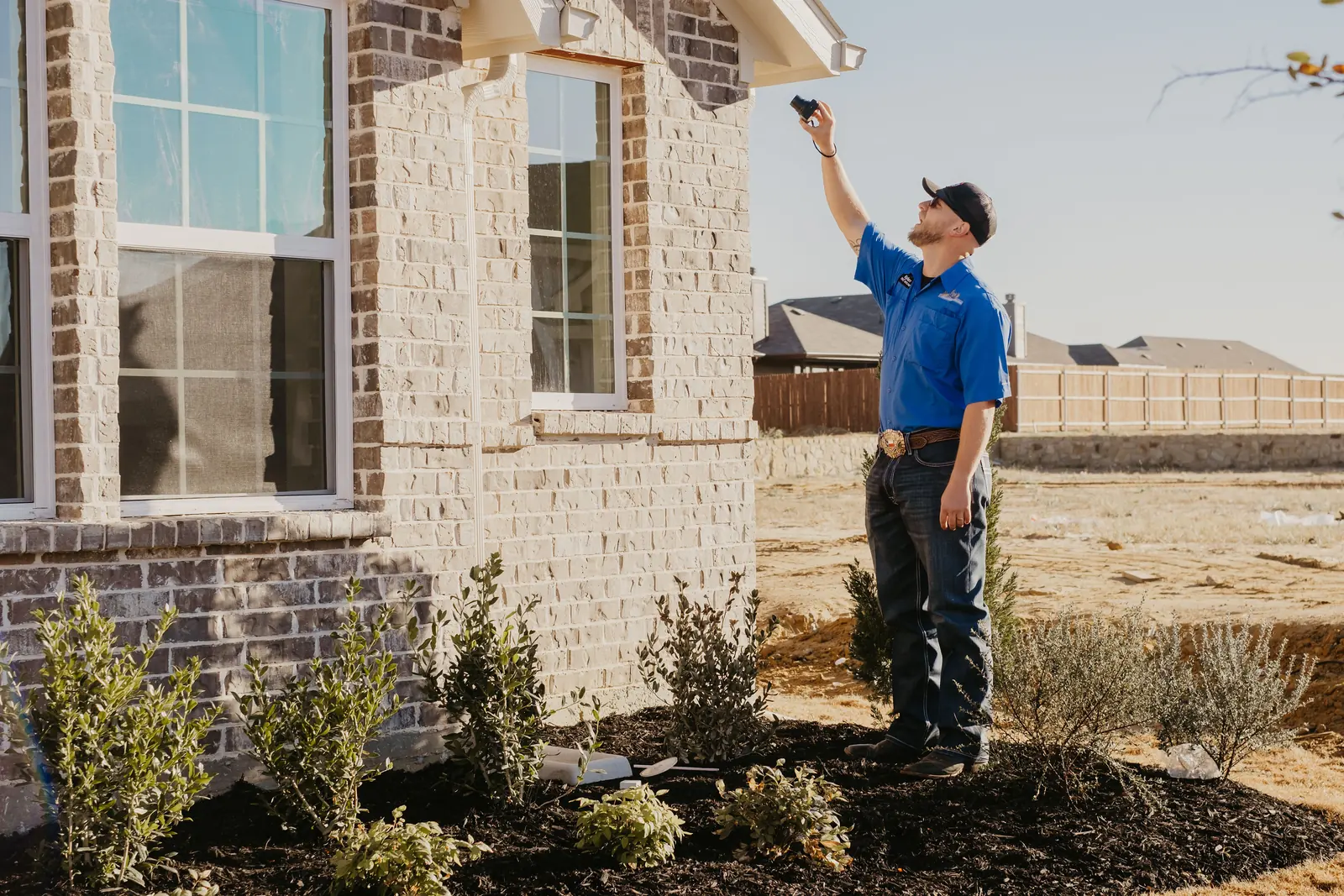 Kissee Inspections inspector checking the exterior of a completed new home for an 11-month warranty inspection
